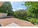 Large brick patio with retaining wall and fenced backyard, perfect for outdoor enjoyment at 2728 Evanston Ave, Durham, NC 27703