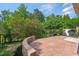 Brick patio with retaining wall and lush landscaping, offering a private outdoor space at 2728 Evanston Ave, Durham, NC 27703