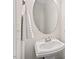 Bright powder room with pedestal sink and oval mirror at 2728 Evanston Ave, Durham, NC 27703