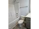 Bathroom featuring a tub, toilet, and vanity with gray cabinets at 29 High Hampton Way, Fuquay Varina, NC 27526