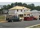 New construction home with visible framing and building materials, with a dumpster in the yard at 29 High Hampton Way, Fuquay Varina, NC 27526