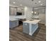 Well-lit kitchen featuring an island, pendant lights, and stainless steel appliances at 29 High Hampton Way, Fuquay Varina, NC 27526