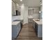 Modern kitchen featuring gray cabinets, white subway tile backsplash, and stainless steel appliances at 29 High Hampton Way, Fuquay Varina, NC 27526