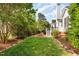 Spacious, grassy backyard is well manicured and features mature trees at 300 Ravenstone Dr, Cary, NC 27518