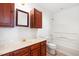 Updated bathroom features cherry wood cabinetry and shower/tub combo at 300 Ravenstone Dr, Cary, NC 27518