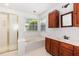 Bathroom featuring a separate shower, soaking tub, and vanity with dark wood cabinets at 300 Ravenstone Dr, Cary, NC 27518