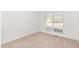 Comfortable, sunlit bedroom with neutral carpet, single window, and spacious design at 300 Ravenstone Dr, Cary, NC 27518