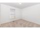 Bright bedroom features large window with blinds and neutral colored walls and carpet at 300 Ravenstone Dr, Cary, NC 27518
