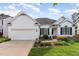 Charming one story home boasts a manicured lawn, attached garage, and classic white siding at 300 Ravenstone Dr, Cary, NC 27518