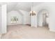 Bright, open living area with neutral carpeting and large windows allowing ample natural light at 300 Ravenstone Dr, Cary, NC 27518