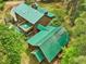Aerial view of a log home with a green metal roof, and a large backyard at 3009 Pleasant Hill Church Rd, Siler City, NC 27344