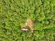 Aerial view of a secluded lot in a verdant, tree-filled area with a partial mobile home at 3009 Pleasant Hill Church Rd, Siler City, NC 27344