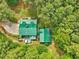 Aerial view of a log home and outbuilding surrounded by trees at 3009 Pleasant Hill Church Rd, Siler City, NC 27344