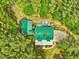 Aerial view of log home with green roof and private, wooded lot at 3009 Pleasant Hill Church Rd, Siler City, NC 27344