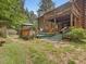 Expansive backyard with a tiered deck, wooden railing, and grass leading into the yard at 3009 Pleasant Hill Church Rd, Siler City, NC 27344