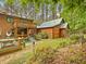 Backyard view of log home with green metal roof and deck at 3009 Pleasant Hill Church Rd, Siler City, NC 27344