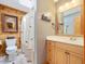 Well-lit bathroom featuring wood paneling, a vanity with cabinets, and a shower with curtain at 3009 Pleasant Hill Church Rd, Siler City, NC 27344