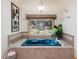 An inviting blue bathtub features tile surround and a decorative window at 3009 Pleasant Hill Church Rd, Siler City, NC 27344