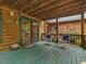 Covered wooden deck features an outdoor seating area to enjoy the natural surroundings at 3009 Pleasant Hill Church Rd, Siler City, NC 27344