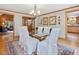 Charming dining room with white chairs, a glass table, and an open view to the kitchen at 3009 Pleasant Hill Church Rd, Siler City, NC 27344