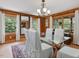 Well-lit dining room with wooden accents, white chairs, and large windows at 3009 Pleasant Hill Church Rd, Siler City, NC 27344