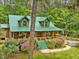 Inviting log home with green metal roof, lovely front porch, and mature landscaping at 3009 Pleasant Hill Church Rd, Siler City, NC 27344