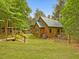 Exterior view of log home with green trim and covered porch at 3009 Pleasant Hill Church Rd, Siler City, NC 27344