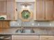 Close-up of a kitchen sink and countertop with stainless steel appliances and a scenic view at 3009 Pleasant Hill Church Rd, Siler City, NC 27344
