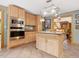 Spacious kitchen with stainless steel appliances, wooden cabinetry, and a center island with cooktop at 3009 Pleasant Hill Church Rd, Siler City, NC 27344