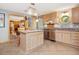 Well-lit kitchen with custom cabinets, tile floors, and an open view of the living area at 3009 Pleasant Hill Church Rd, Siler City, NC 27344