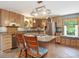 Kitchen features wooden cabinets, stainless appliances, and a kitchen island with gas cooktop and seating at 3009 Pleasant Hill Church Rd, Siler City, NC 27344