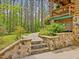 Stone steps and retaining wall in landscaped backyard, leading to the house at 3009 Pleasant Hill Church Rd, Siler City, NC 27344