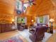 Bright living room with a vaulted ceiling, wood paneling, and a cozy sitting area at 3009 Pleasant Hill Church Rd, Siler City, NC 27344