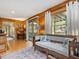 Comfortable living room with wood paneled walls and a sliding glass door that leads to the outdoor deck at 3009 Pleasant Hill Church Rd, Siler City, NC 27344