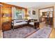 Living room with wood paneled walls, wooden furnishings and accent rugs that create a warm inviting space at 3009 Pleasant Hill Church Rd, Siler City, NC 27344