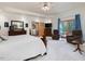Bright main bedroom with a king-size bed, sitting area, and en-suite bathroom access at 3009 Pleasant Hill Church Rd, Siler City, NC 27344