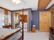 Serene main bedroom showcasing wood paneling, an ensuite bathroom, and ample natural light at 3009 Pleasant Hill Church Rd, Siler City, NC 27344