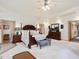 Bright main bedroom featuring a ceiling fan, king bed, and sitting area with plush decor at 3009 Pleasant Hill Church Rd, Siler City, NC 27344
