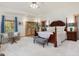 Serene main bedroom with a king-size bed, sitting area, and sliding doors to the outside deck at 3009 Pleasant Hill Church Rd, Siler City, NC 27344