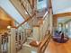 Open staircase with wooden railing accents the natural wood interior at 3009 Pleasant Hill Church Rd, Siler City, NC 27344
