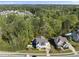Aerial view of a home with a pool, wooded surroundings, and neighborhood landscape at 3138 Curling Creek Dr, Apex, NC 27502