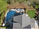 Backyard aerial view featuring a gunite pool with water feature, outdoor seating, and meticulously manicured lawn at 3138 Curling Creek Dr, Apex, NC 27502