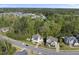 Aerial view of two homes nestled in a lush neighborhood with mature trees and well-maintained landscaping at 3138 Curling Creek Dr, Apex, NC 27502
