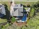 Backyard aerial view featuring lush landscaping, a pristine pool, putting green and outdoor entertaining areas at 3138 Curling Creek Dr, Apex, NC 27502