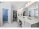 Stylish bathroom with double vanity, modern finishes, and a view into the large walk-in closet at 3138 Curling Creek Dr, Apex, NC 27502