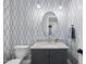 Charming bathroom with patterned wallpaper, granite vanity, and stylish lighting at 3138 Curling Creek Dr, Apex, NC 27502