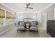 Bright bedroom boasts a cozy sitting area, neutral tones, and large windows at 3138 Curling Creek Dr, Apex, NC 27502