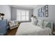 Comfortable bedroom featuring a cozy chair, white bedding, and bright natural light at 3138 Curling Creek Dr, Apex, NC 27502