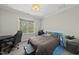 Cozy bedroom features a large window, comfortable bed, and a dedicated workspace at 3138 Curling Creek Dr, Apex, NC 27502