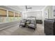 Spacious bedroom featuring a sitting area, neutral decor, and natural light from large windows at 3138 Curling Creek Dr, Apex, NC 27502